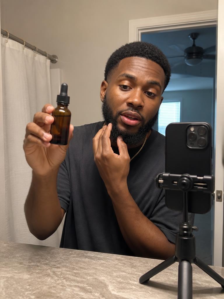 Creator demonstrating a grooming product with a phone on a tripod
